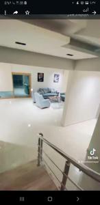 a living room with a couch and a table at فيلاه مستقله ٤ غرف نوم ٤ حمامات لاندسكيب حمام سباحه خصوصيات كامله in El Alamein