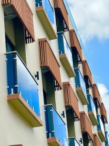 a building with blue balconies on the side of it at Aster Apartment Bali in Canggu