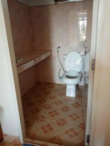 a bathroom with a white toilet in a room at Phuphamok Valley Resort in Ban Na Dan