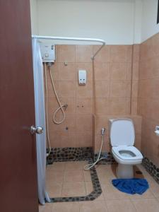 a bathroom with a toilet and a shower at Phuphamok Valley Resort in Ban Na Dan