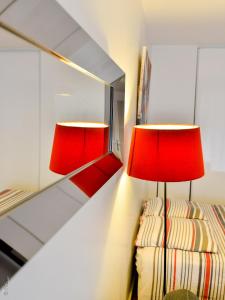 a bedroom with two lamps and a mirror at Appartement Monplaisir Part Dieu in Lyon