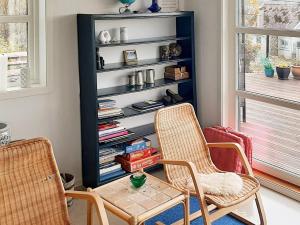 a living room with two chairs and a book shelf at 8 person holiday home in Tau-By Traum in Tau