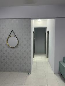 a hallway with a mirror hanging on a wall at Alfaruqi Homestay Seaview in Beserah