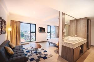 a bathroom with a sink and a living room at Kamaniiya Petitenget Seminyak in Seminyak