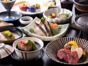 una mesa llena de platos de comida en una mesa en Kotohira Kadan en Kotohira