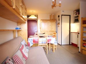 シャンルッスにあるStudio cabine à Chamrousse, RDC, balcon nord, au pied des pistes, bien équipé - FR-1-340-274のテーブルとキッチン付きの小さな部屋