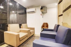 a waiting room with chairs and an air conditioner at Rcc Hotel Banjara Hills in Hyderabad