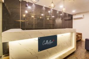 a counter at a coffee shop with a marble wall at Rcc Hotel Banjara Hills in Hyderabad