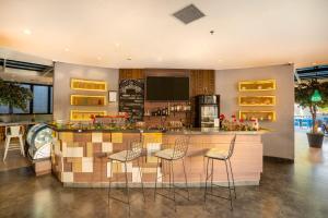 a kitchen with a bar with stools at Kamaniiya Petitenget Seminyak in Seminyak