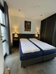 um quarto com duas camas num quarto em Enkhuizer Strand Chalet Beach Oase Erste Reihe mit Zaun Haus Nr 248 em Enkhuizen