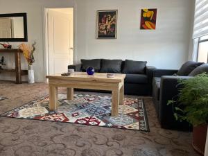 a living room with a couch and a coffee table at Casa in Punta Arenas