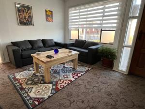a living room with a couch and a coffee table at Casa in Punta Arenas