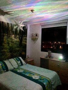 a bedroom with a bed and a ceiling with lights at Best View of Pimentel in Pimentel