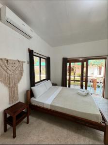 a bedroom with a large bed and a window at Casa De Loren in General Luna