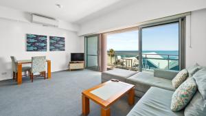 a living room with a couch and a table at Sea Side 211 in Mandurah
