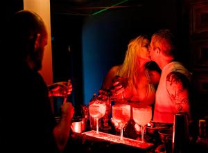 a group of people sitting at a table with wine glasses at RioZin Pousada Liberal - Somente Adultos - Clothing Optional - Lifestyle Hotel in Rio de Janeiro