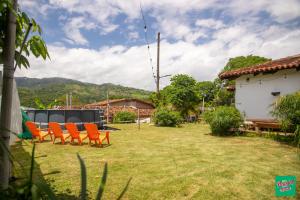 a group of orange chairs sitting in a yard at Don Paco's Country House in Copán Ruinas