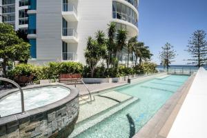 a swimming pool in front of a building at Reflections Tower Two in Gold Coast