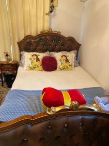 a bedroom with a bed with a stuffed bird on it at yiyi tokyo disney minpaku in Tokyo