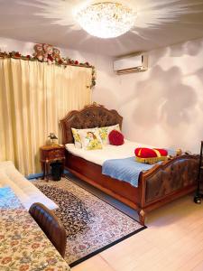 a bedroom with a large wooden bed with red pillows at yiyi tokyo disney minpaku in Tokyo