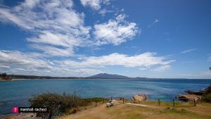 a view of a body of water with a mountain at Bermagui Breeze Holiday House 5 bedroom 18-20 Mumbulla Street - Bermagui in Bermagui