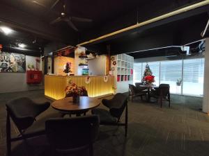 una sala de espera con mesa y sillas y un árbol de Navidad en Ryokan Chic Hotel en Petaling Jaya