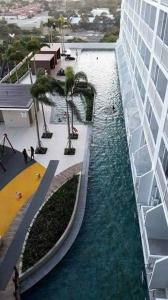 a view of a pool of water next to a building at Studio unit at The Breeze Residence in Manila