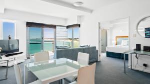 a living room with a couch and a bed and a television at Sea Side 411 in Mandurah