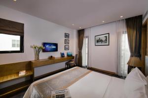 Postel nebo postele na pokoji v ubytování Hanoi Paon Hotel & Spa