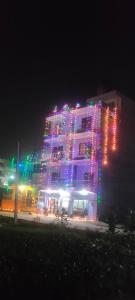 a building with christmas lights on it at night at Kavre Guest House in Lumbini