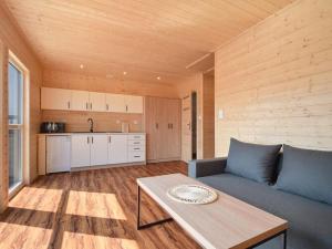 a living room with a couch and a table at Cozy holiday homes for 4 people, azy in Łazy