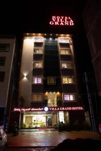 a hotel with a sign that reads villa grand hotel at Hotel Grand Villa in Yelahanka