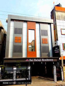 a building on a street with a sign in front of it at Sai Balaji Residency in Shirdi