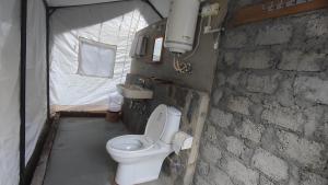 a bathroom with a toilet in a tent at Hail Himalayas in Chail