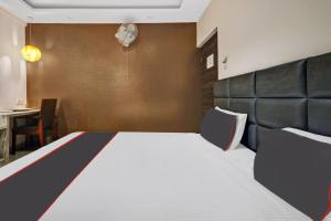 a bedroom with a large bed with a leather headboard at Manasi Residency in Bangalore
