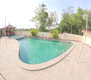 a large swimming pool with blue water at BMR B3 Homestay Jogja in Ngingas