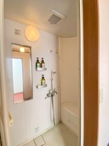 a bathroom with a shower and a sink at Yoshidaya Ryokan in Zaō Onsen