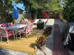 a patio with a table and chairs and an umbrella at Mango Beach House in Lake Worth