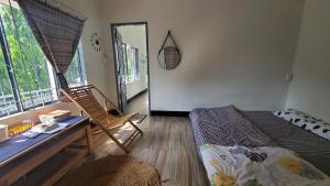 a room with a bed and a chair and a mirror at Chú Trọc Homestay - Phan Rang Homestay & Camp in Phan Rang–Tháp Chàm