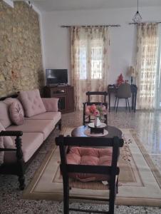 a living room with a couch and a table at Artemis House in Agios Nikolaos