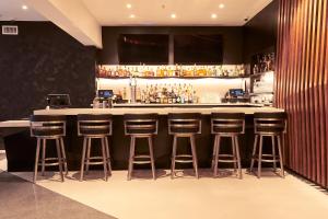 a bar with bar stools in a room at Champions Club Texas in Houston