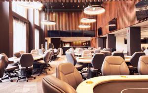 a waiting room with rows of tables and chairs at Champions Club and Hotel, Houston Westchase in Houston