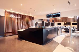a lobby with a reception desk in a building at Champions Club and Hotel, Houston Westchase in Houston