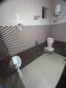 a bathroom with a toilet and a sink at Punjabi Residency(niwas) in Amritsar