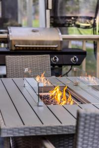 a barbecue grill with fire on a picnic table at Swing into Summer at our Mountain Home with a River View in Blairsden
