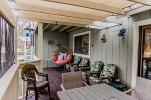 una veranda con sedie, tavolo e finestra di Swing into Summer at our Mountain Home with a River View a Blairsden