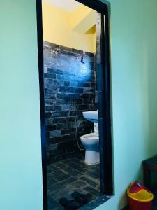 a bathroom with a toilet and a sink at Bandipur Samira Homestay - Experience the Best for Less in Bandīpur