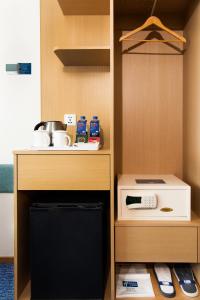 a kitchen with a stove and a microwave at Holiday Inn Express Macau City Centre, an IHG Hotel in Macau