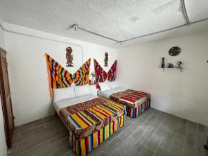 a bedroom with two beds in a room at AKBAL Holbox - Beach Zone in Holbox Island