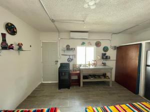 a kitchen with a stove and a sink in a room at AKBAL Holbox - Beach Zone in Holbox Island